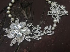 "Perfect for all bridal or party to wear!! Romantic shaped necklace featuring sparkle flower pendants and linked with pearl chains. Color: clear rhinestone crystals with pearls Size: necklace measures around 19.5\" long and large flower pendants around 6\" long x 3.25\" width Item ship out with tracking number to you (around 10 to 14 business days for delivery). We also provide fast shipping service, around 3-4 business days delivery but need to add extra charge. Please convo us if need." Pearl Flower Necklace For Wedding, Wedding Rhinestone Necklace With Pearl Chain, Wedding Crystal Necklace With Flower Design, Wedding Crystal Flower Necklace, Flower Crystal Wedding Necklace, White Pearl Flower Necklace For Weddings, Silver Flower Pearl Necklace For Wedding, Wedding Pearl Drop Flower Pendant Necklaces, Wedding Pearl Drop Flower Pendant Necklace