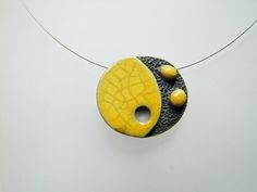 Unique raku ceramic necklace. This necklace is made of a bead entirely shaped by hand. Lava stone texture effect contrasting with the smooth and shiny yellow and crackled enamel. A unique piece inspired by the world of Japanese cartoons and modern art. Textured bead with beautiful crackling effects specific to raku firing. Length of the steel cable adjustable from 39 to 44 cm. Closing by steel snap hook and extension chain of 5cm. If needed I can adapt the length to your needs on request.   Necklace delivered in its pocket ready to offer. For a gift I can slip a word of your share in the package. The stages of manufacture -My beads are handmade. -A first firing in an electric kiln, then enameling session while concentrating to give a neat rendering. -A second firing in a Raku kiln: in this Raku Firing, Raku Kiln, Raku Ceramics, Beautiful Handwriting, Ceramic Necklace, Japanese Cartoon, Stone Texture, Illustrator Tutorials, Ceramic Jewelry