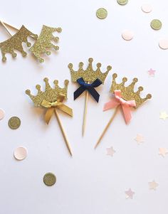 three little princess crowns on sticks with confetti and gold glitters around them