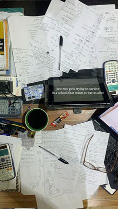 many papers and calculators on a desk with a quote written in the middle