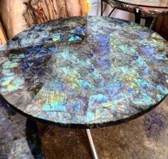 a table that has some kind of blue marble on it and is sitting next to another table