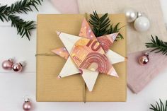 an origami star on top of a gift wrapped in brown paper