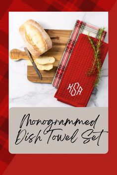 a wooden cutting board topped with bread next to a red towel