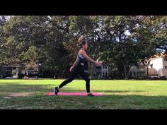 a woman is doing yoga in the park