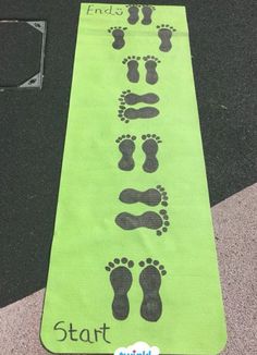 a green runner's mat with footprints on it and the words start written in black