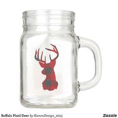 a glass jar with a deer drawn on the side and red flannel plaid