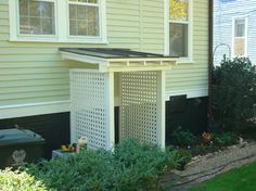 an outside view of a house with plants in the front yard