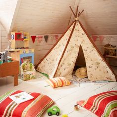 a child's bedroom with a teepee tent and toys