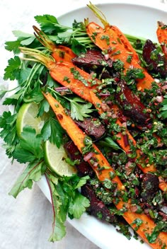 a white plate topped with carrots and cilantro