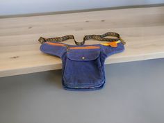 Hip bag with many special pockets.   Finished size:  18.5" width x 10.25" height.  Cargo pocket 6.5" x 6.75" x 1"; main zipper pockets 7" x 7"; front slip pocket 3.5" x 2.75; small zipper pocket 5" x 2.5".  Adjustable waist: 34" - 46".   This bad is made using waxed canvas - accented with antique bronze hardware. Multifunctional Belt Bag With Pockets For Travel, Multifunctional Rectangular Belt Bag With Pockets, Rectangular Belt Bag With Pockets For Daily Use, Functional Rectangular Belt Bag With Pockets, Travel Shoulder Pouch With Pockets, Practical Travel Pouch With Pockets, Practical Shoulder Bag With Pockets In Pouch Shape, Multifunctional Shoulder Belt Bag With Pockets, Blue Travel Shoulder Bag With Side Pockets