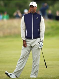 a man standing on top of a green holding a golf club