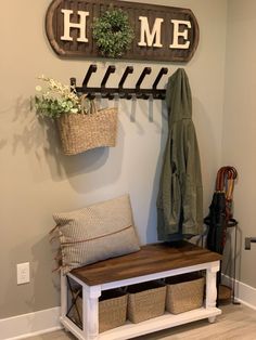 a coat rack and bench in the entryway to a home with baskets on it