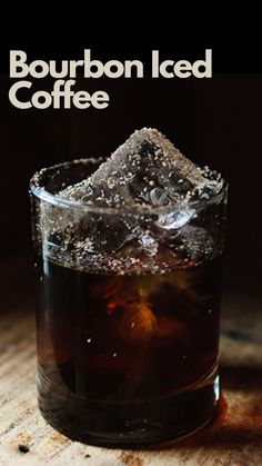 bourbon iced coffee in a glass with ice cubes on the rim and text bourbon iced coffee