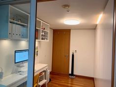 a computer desk sitting in the middle of a room