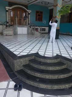 a man standing on top of a set of stairs