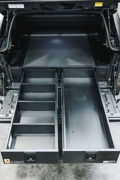 the back end of a vehicle with its doors open and drawers opened to show what's inside