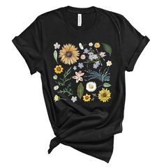 a black t - shirt with sunflowers and other flowers on it