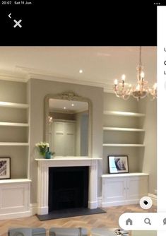 an image of a living room with fireplace and built in bookshelves on the wall