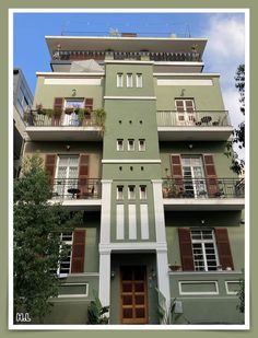 an apartment building with balconies on the second floor