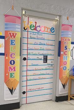 a welcome sign is on the front door of a school room with colorful banners hanging from the wall