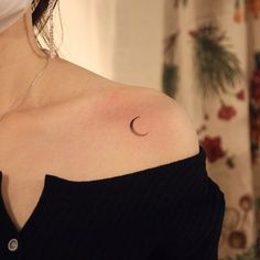 a woman with a crescent tattoo on her shoulder