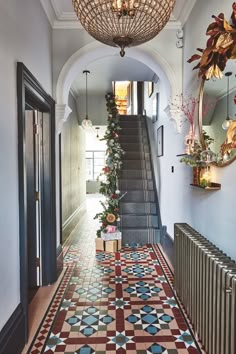 the hallway is decorated with colorful tiles and decorative lighting fixtures, along with an ornate chandelier