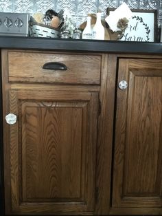 a wooden cabinet with two doors and drawers