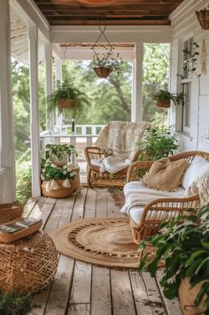 a porch with wicker furniture and potted plants