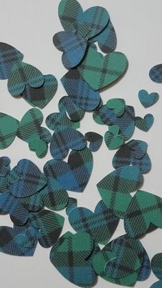 green and blue hearts are scattered on a white surface