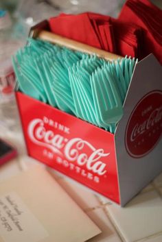 an open coca cola box on top of a table