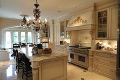 a large kitchen with an island and chandelier