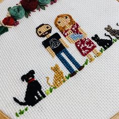 a cross stitch pattern with two people and their dogs in the middle, surrounded by flowers