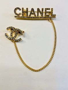 This CC brooch pin is beautiful and great quality. Alloy with Gold Plating, Gold Chain accent and rhinestones. 2 inches Across 1/2 inch Down Chain- 4 1/2 inches Down Little CC Pin- 3/4 inches Across, 1/2 inch Down Very cute! Perfect for blazer/jackets, hats, shirts and more! Cc Brooch, Bracelets With Charms, Run The Jewels, Chanel Brooch, Chanel Chain, Chanel Inspired, Cross Chain, Luxe Life, Dope Jewelry