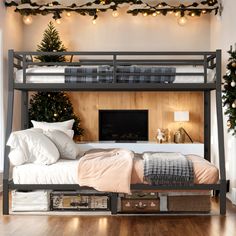 a bunk bed with christmas lights on the ceiling and a fireplace in the corner next to it