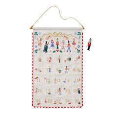 a christmas calendar hanging on a wall with two small figurines next to it