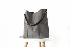 Stylish and classic grab and go large hobo bag.  Great everyday bag that will keep you organized with plenty of pockets on the inside and two pockets on the outside. Light, sturdy and comfortable on the shoulder due to the wide strap.  *Made of durable upholstery canvas fabric in medium gray color.  *Cowhide leather strap in black.  *Fully lined with solid gray cotton fabric . * 4 large slip inner pockets * Magnetic button closure  Dimensions: Width: 13.5 in (35 cm) Height: 13 in (33 cm) Bottom Slouchy Purse, Canvas Bucket Bag, Soft Leather Tote, Winter Bags, Suede Tote Bag, Large Hobo Bag, Bag Minimalist, Everyday Tote Bag, Everyday Purse