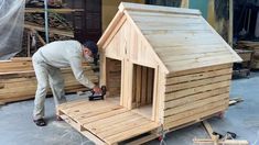 a man is building a dog house out of pallets