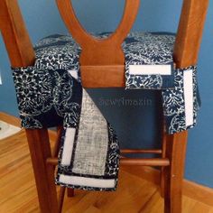 a wooden chair with a black and white seat cover on it's armrests