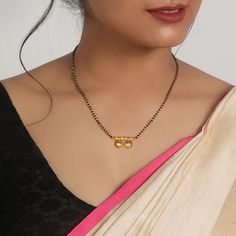 The Inspiration: A symbol of love embarking on a different glow and charm. This ethnic piece is perfect for your other half. The Design: This design is making a statement with a unique embellishment of this gold-plated musing. 
 The Stylin 
 With this mangalsutra, you can embrace the classic, traditional, and vibrant style. 
 
 925 Silver 
 
 Chain length: 43 cm +  2.5 cm adjustable  
 Charm Dimension: 14 mm x 28 mm  
 Comes with the Jewellery kit and authenticity certificate Dual-tone Gold Plated Jewelry, 22k Gold Jewelry For Puja, Motif Jewelry For Celebrations, Elegant Jewelry With Motifs For Puja, Gold Necklaces With Diwali Motifs, Gold Necklaces With Motifs For Diwali, Gold Necklace With Diwali Motifs, Motif Necklaces For Festivals, Gold Jewelry With Motifs For Gift