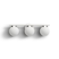 three white balls are hanging on the wall