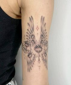 a woman's arm with an owl tattoo on the left side of her body