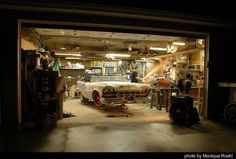 an old car is parked in the garage