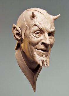 a statue of an old man with horns on his head