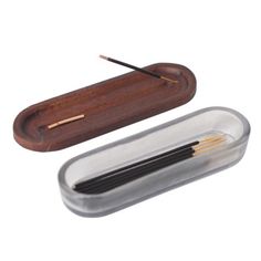 a pen case with two pens in it and a pencil holder next to it on a white background