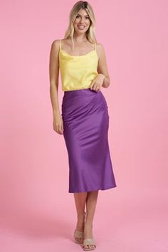 Introducing our luxurious purple satin midi skirt, the perfect addition to any fashion-forward wardrobe. Crafted from high-quality satin fabric, this skirt boasts a lustrous sheen and a silky-smooth texture that feels incredibly soft against the skin. Designed with a flattering midi length, this skirt falls elegantly to the mid-calf, making it a versatile piece that can be dressed up or down for any occasion. The deep shade of purple adds a bold and sophisticated touch to any outfit, making it a Spring Party Satin Pencil Skirt, Chic Satin Pencil Skirt For Party, Purple Satin Skirt Outfit, Satin Summer Skirt, Summer Midi Satin Skirt, Summer Satin Pencil Skirt, Elegant Purple Satin Bottoms, Elegant Purple Maxi Skirt For Summer, Elegant Purple Maxi Skirt