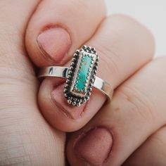 This beautiful ring features a stunning aqua blue Royston turquoise gemstone in a long rectangle shape. The sterling silver setting is adorned with delicate beaded details. This ring is a truly eye-catching piece that would make a wonderful addition to any jewelry collection. The Royston turquoise gemstone is known for its unique color and striking patterns, making it a highly sought-after stone. The aqua blue color of this particular gemstone is simply gorgeous. The long rectangle shape is also Bohemian Jewelry With Rectangular Gemstone, Bohemian Rectangular Gemstone Jewelry, Sterling Silver Stackable Rectangular Jewelry, Stackable Rectangular Sterling Silver Jewelry, Bohemian Silver Rectangular Ring, Rectangular Turquoise Gemstone Ring, Bohemian Sterling Silver Ring With Rectangular Shape, Bohemian Turquoise Rectangular Jewelry, Rectangular Blue Turquoise Sterling Silver Ring