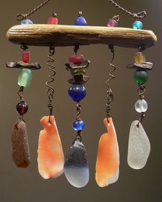 a cell phone with an image of sea glass wind chime hanging from it