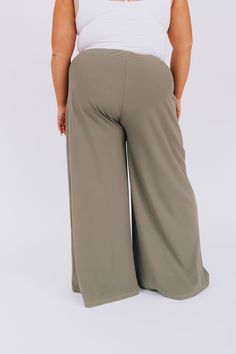 Our PLUS SIZE - Beyond Compare Pants are the perfect addition to your closet! Made with a smokey sage color and wide-legged style, these pants are sure to add a stylish touch to any look. Plus, they boast an elastic waistband for comfort and convenient pockets for convenience. So go ahead—it's impossible to go wrong with these pants! Details Wide leg Elastic waistband Pockets! Soft Sizing Approximate measurements: SIZE LENGTH WAIST INSEAM 1XL 43” 32” 31” 2XL 43” 34” 31” 3XL 44” 36” 31” Fabric has stretch Model is 5’8” wearing 3XL Material 92% Nylon 8% SpandexHand wash cold No bleachHang dryOr dry clean Fall Wide Leg Khaki Pants With Elastic Waistband, Khaki Wide Leg Pants With Elastic Waistband For Fall, Chic Olive High-waisted Pants, Khaki Wide Leg Cargo Pants, Chic Full Length Khaki Wide Leg Pants, Olive Wide-leg Pants For Spring, Olive Wide-leg Spring Pants, Olive Wide Leg Pants With Elastic Waistband, Khaki Wide Leg High-waisted Pants With Elastic Waistband