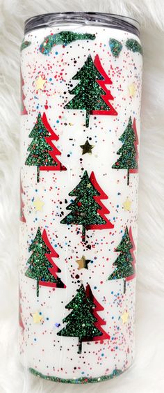 a white can with red and green christmas trees on it