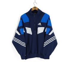 Welcome to our shop. We are waiting for your wishes, also don't be afraid to ask any questions. If you like something from our clothes, just add  to favourites or write to us. Follow us on instagram - @cashalot.store  - ITEM -  Rare Vintage men's ADIDAS half zip blue white sweatshirt Size M retro sportwear basic jumper made in Thailand - SIZE - Size Label (M) M L fit Pit - to - Pit - 25,6 (65cm) Sleeve from neck - 32,3 (82cm) Length - 28 (71cm) (all our items are measured laying flat) - CONDITION -  Total condition 8/10 Please check all Photos , also i can make detailed photos All needed questions ask before buying! - DELIVERY INFO - * All the parcels have a tracking number * All the items will be shipped after successful payment transaction within 1-3 business days. * International shipme Blue Sportswear Sweatshirt For Sports Events, Blue Crew Neck Track Jacket For Streetwear, Blue Three Stripes Sweatshirt For Winter, Blue Sweatshirt With Three Stripes Branding For Winter, Blue Athleisure Sweatshirt With Three Stripes Branding, Blue Winter Sweatshirt With Three Stripes Branding, Blue Sporty Crew Neck Track Jacket, Blue Crew Neck Track Jacket, Blue Retro Sweatshirt For Sports